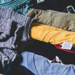 A neat arrangement of clothes and T-shirts in a drawer, showcasing casual wear.